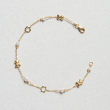 Pulsera en oro amarillo con flores, ositos y perlas intercaladas